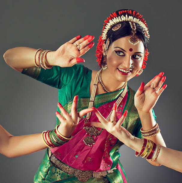Girl, dressed in traditional national costume, dancing classical indian dance Kuchipudi.